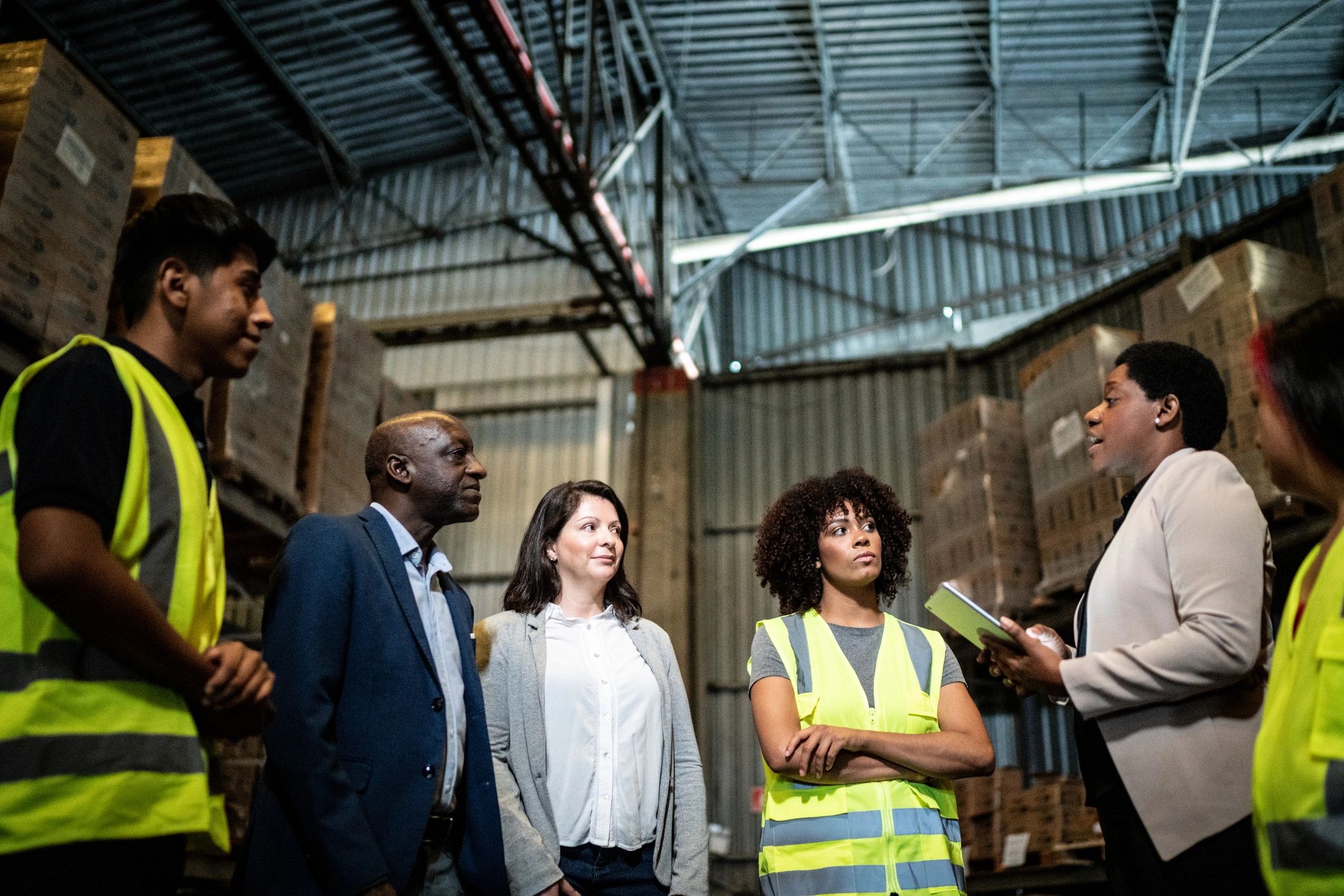 Logistics team meeting in a warehouse environment
